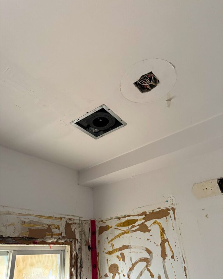 Bathroom ceiling with the old fan and light before replacement