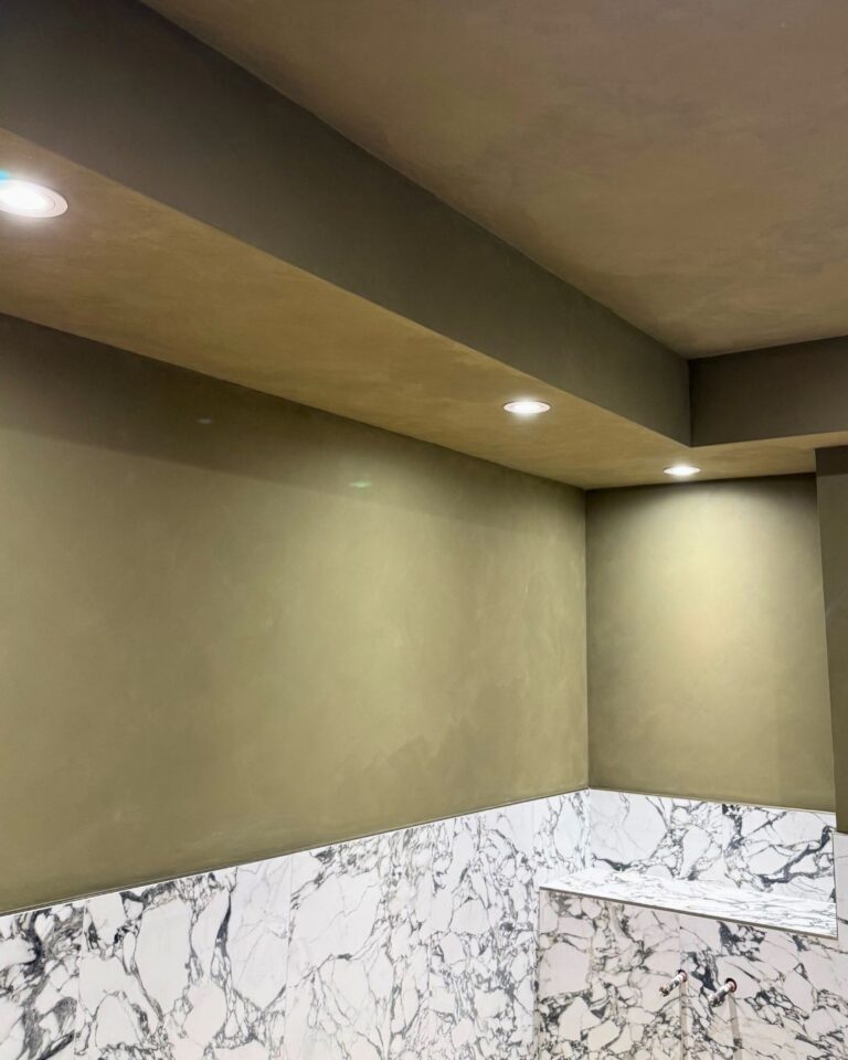 Finished bathroom with pot lights and marble tile