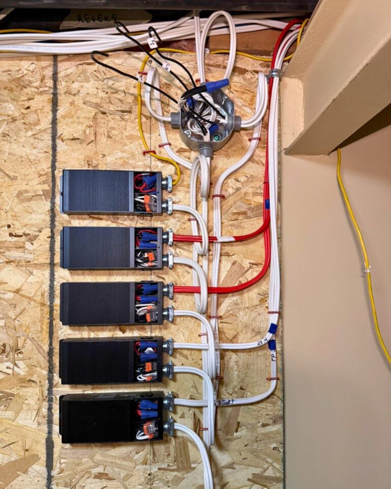 Electrical wiring and power supply units mounted on a basement wall