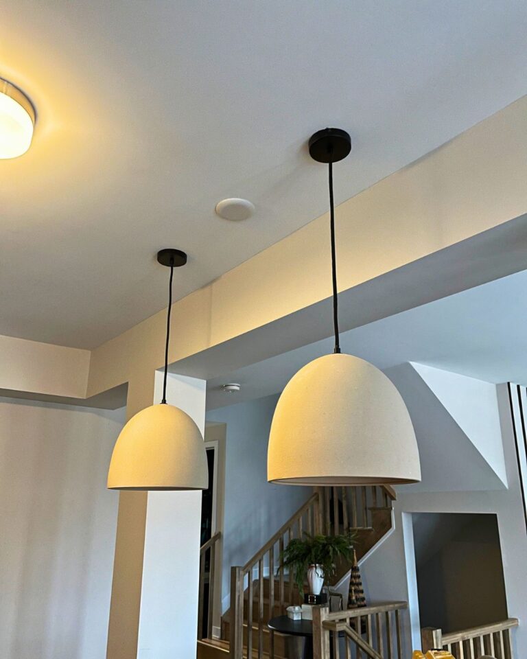 White dome pendant lights installed near a staircase